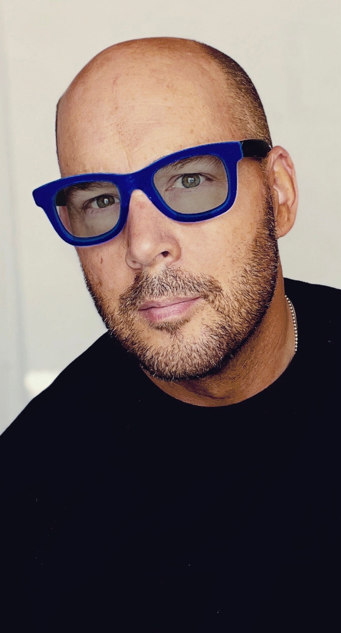 contemporary artist Teddy McDonald man wearing blue velvet eye glasses stubble beard bald head italian fashion italia independent